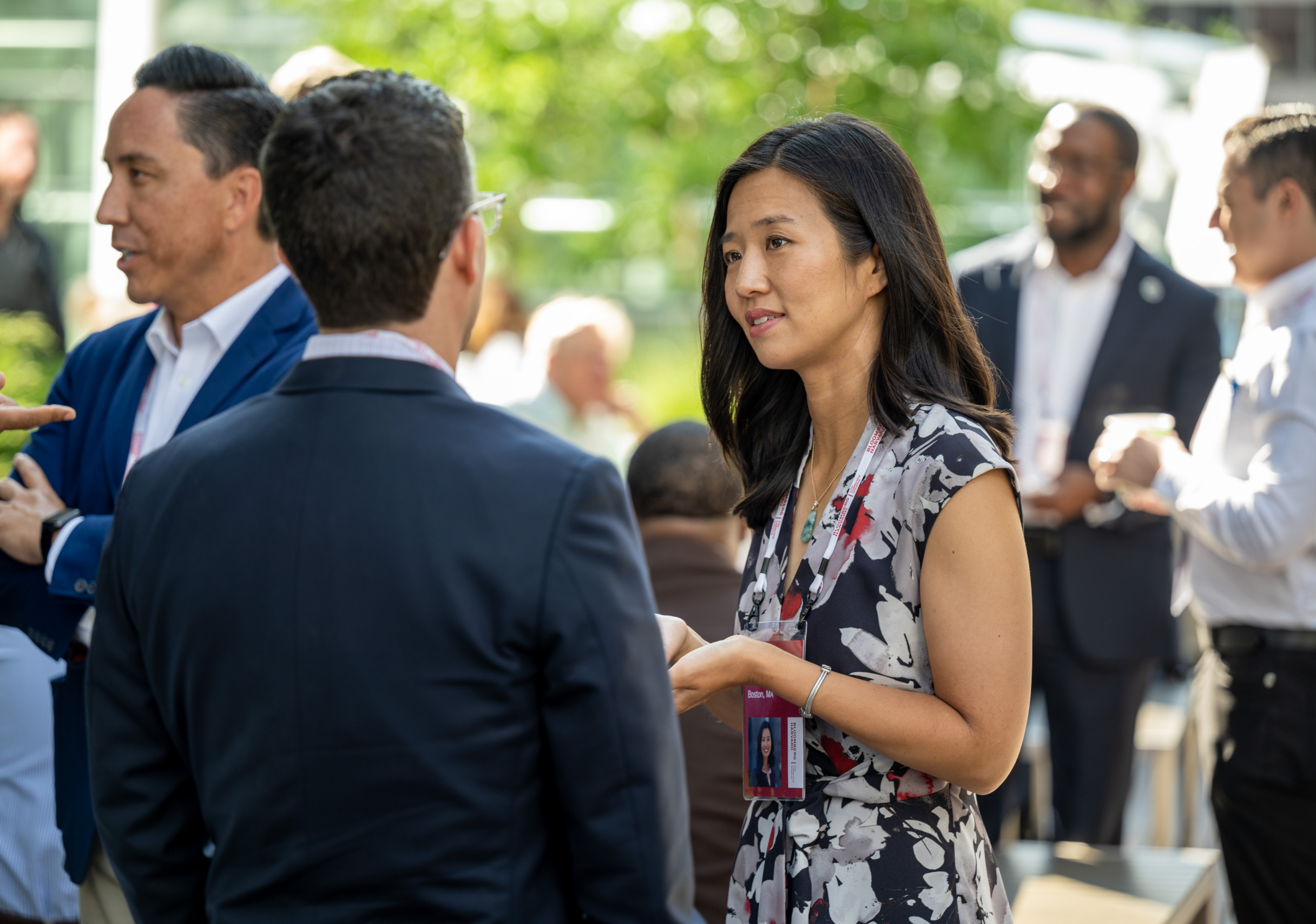 Mayor Michelle Wu of Boston, MA discusses important city work with fellow mayors and senior leaders at an outdoor summer event at Bloomberg Headquarters in New York, New York.