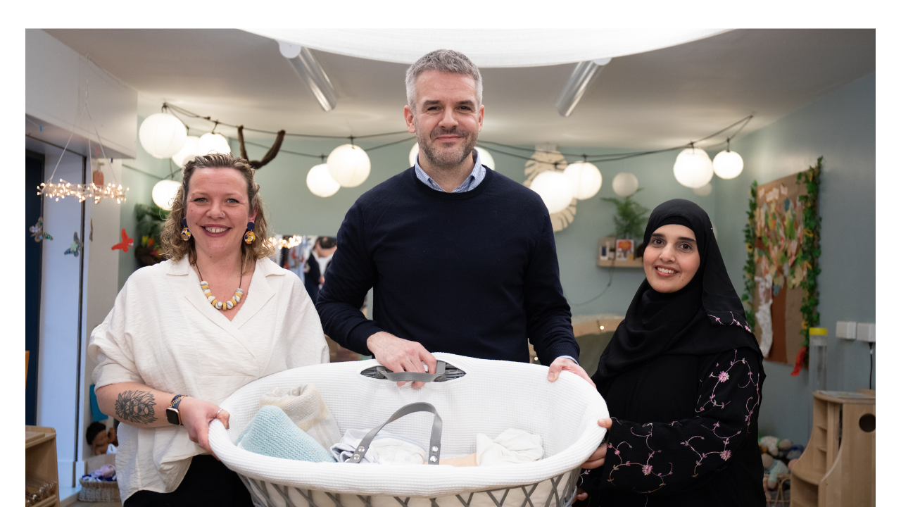 South Yorkshire Mayor Oliver Coppard holds a baby bassinet with partners from the Beds for Babies Initiative