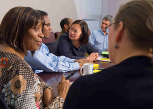 people in a meeting sitting at a table