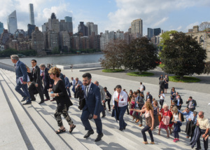 People walking up the steps of a city building