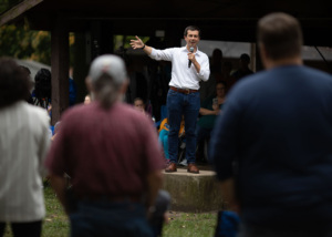 mayor standing on a stage speaking to an audience