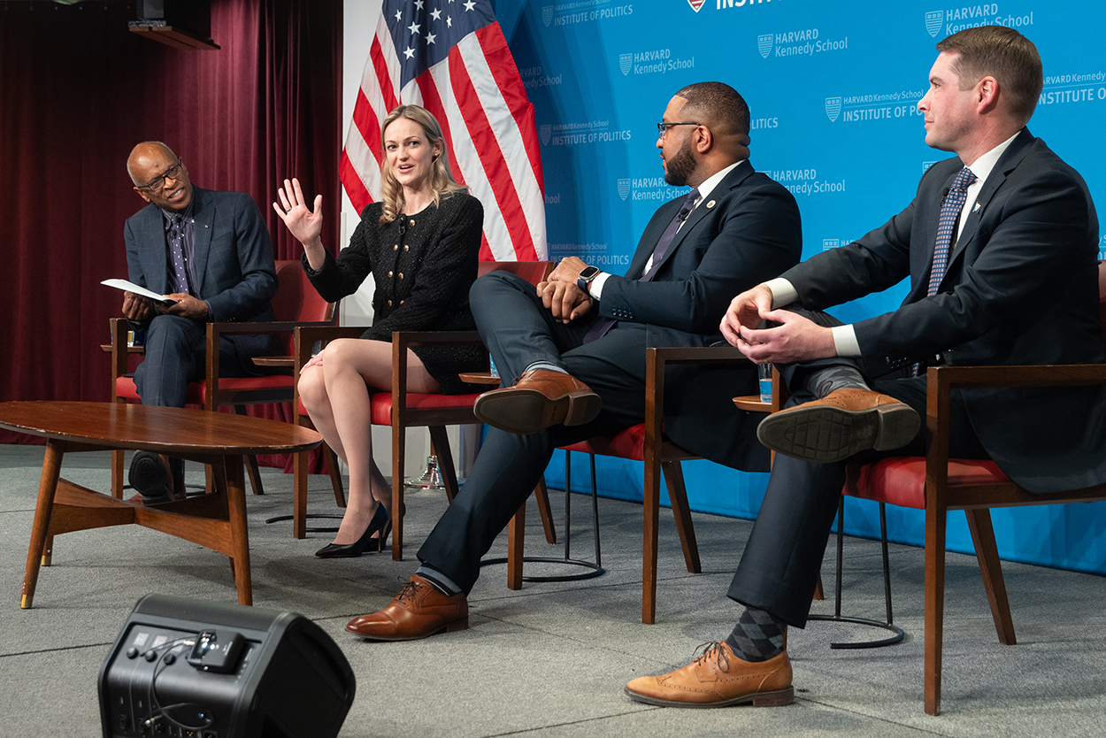 Harvard professor and three mayors on a stage